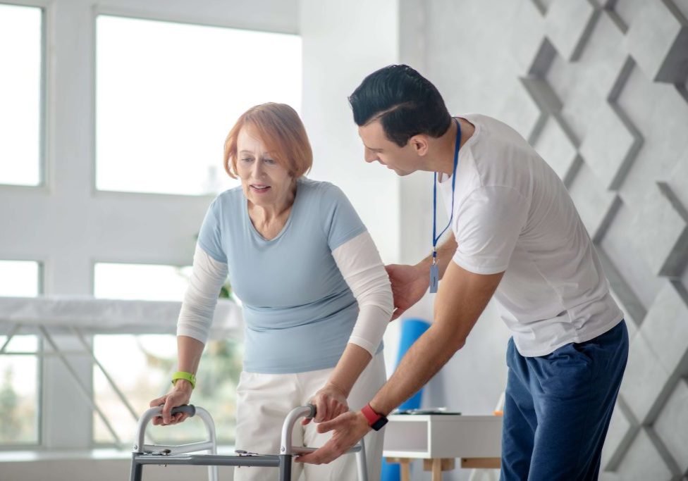 Instructor + woman walking frame