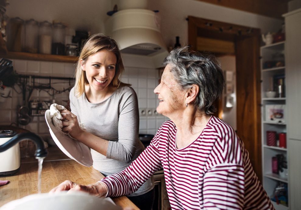 Young and older woman doing the dishes