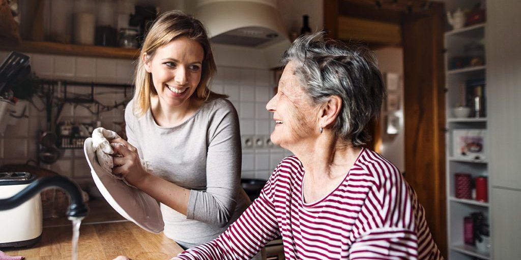 Young and older woman doing the dishes