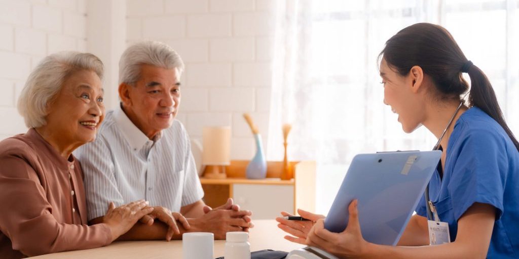 elderly-asian-couple-talking-to-nurse