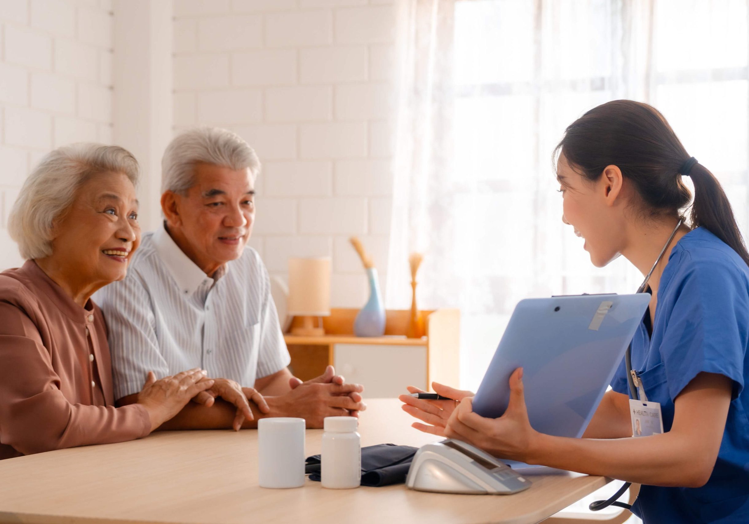 elderly-asian-couple-talking-to-nurse